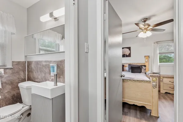 a bathroom with a sink a toilet and a mirror