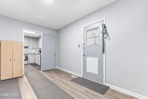 a view of a kitchen from a hallway