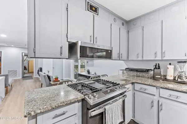 a kitchen with stainless steel appliances granite countertop a stove and a sink