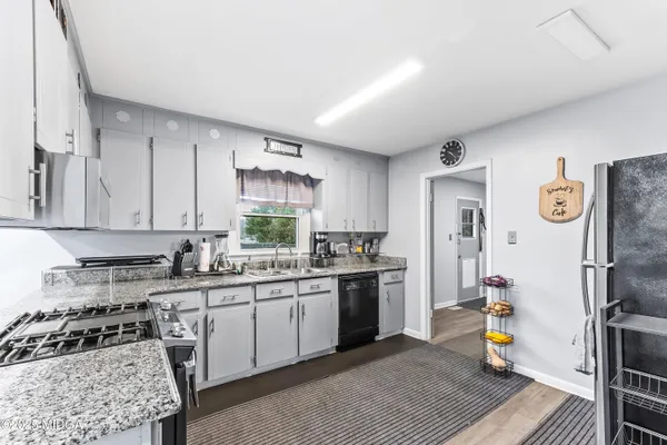 a kitchen with a sink a stove and refrigerator