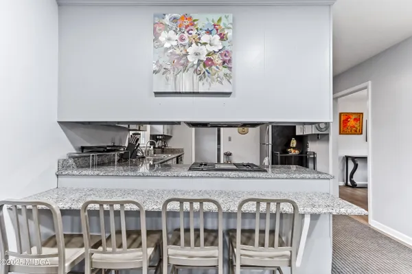 a view of a dining room with furniture and a kitchen