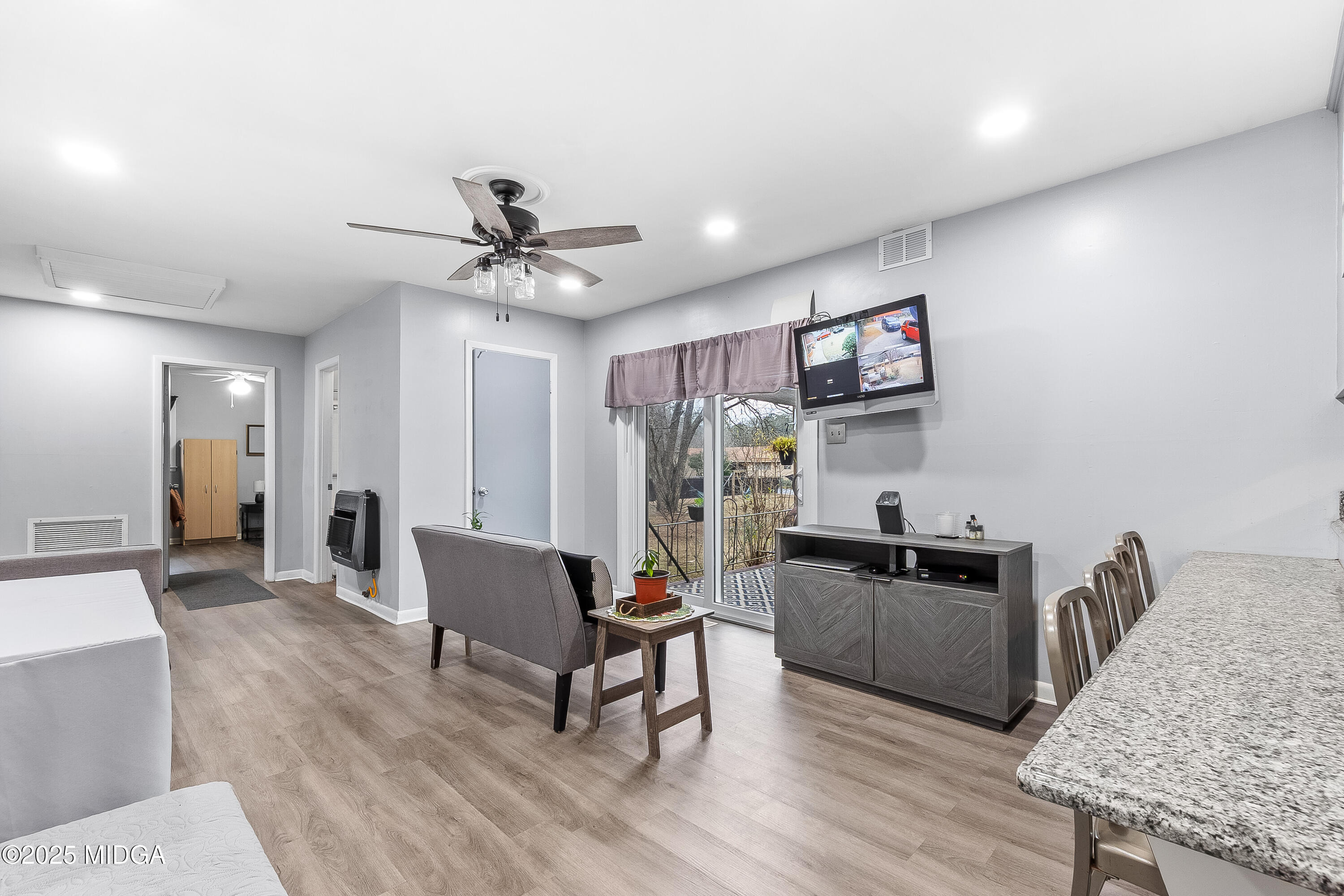 121 Crestwood Road Warner Robins, GA 31093 - Photo 25 of 47 a living room with furniture a dining table and chairs with wooden floor