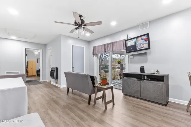 a living room with furniture and a wooden floor