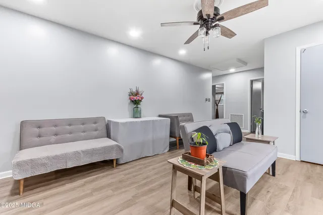 a living room with furniture and wooden floor