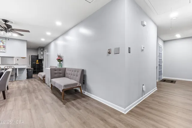 a living room with furniture and a wooden floor