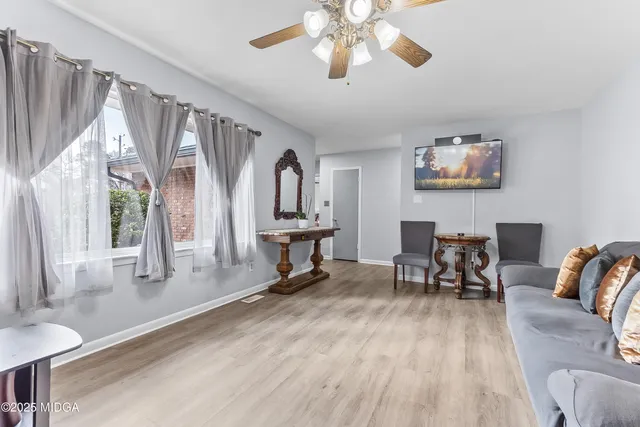 a view of a livingroom with furniture window and wooden floor
