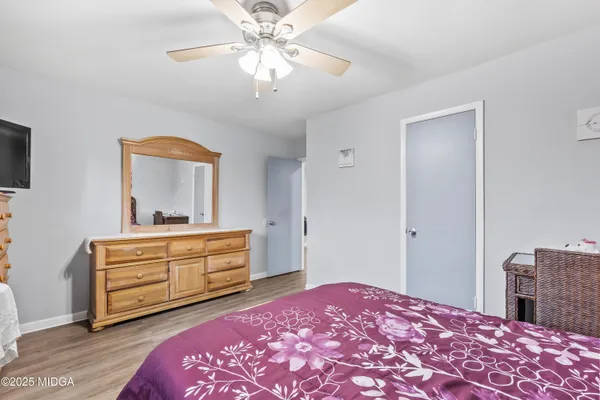 a bedroom with a bed and a dresser