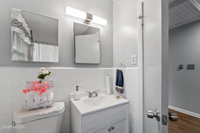 a bathroom with a sink vanity and mirror