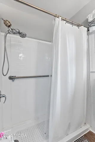 a bathroom with a shower and a shower curtain