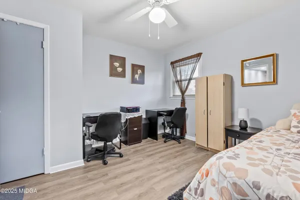 a bedroom with a bed and a chair