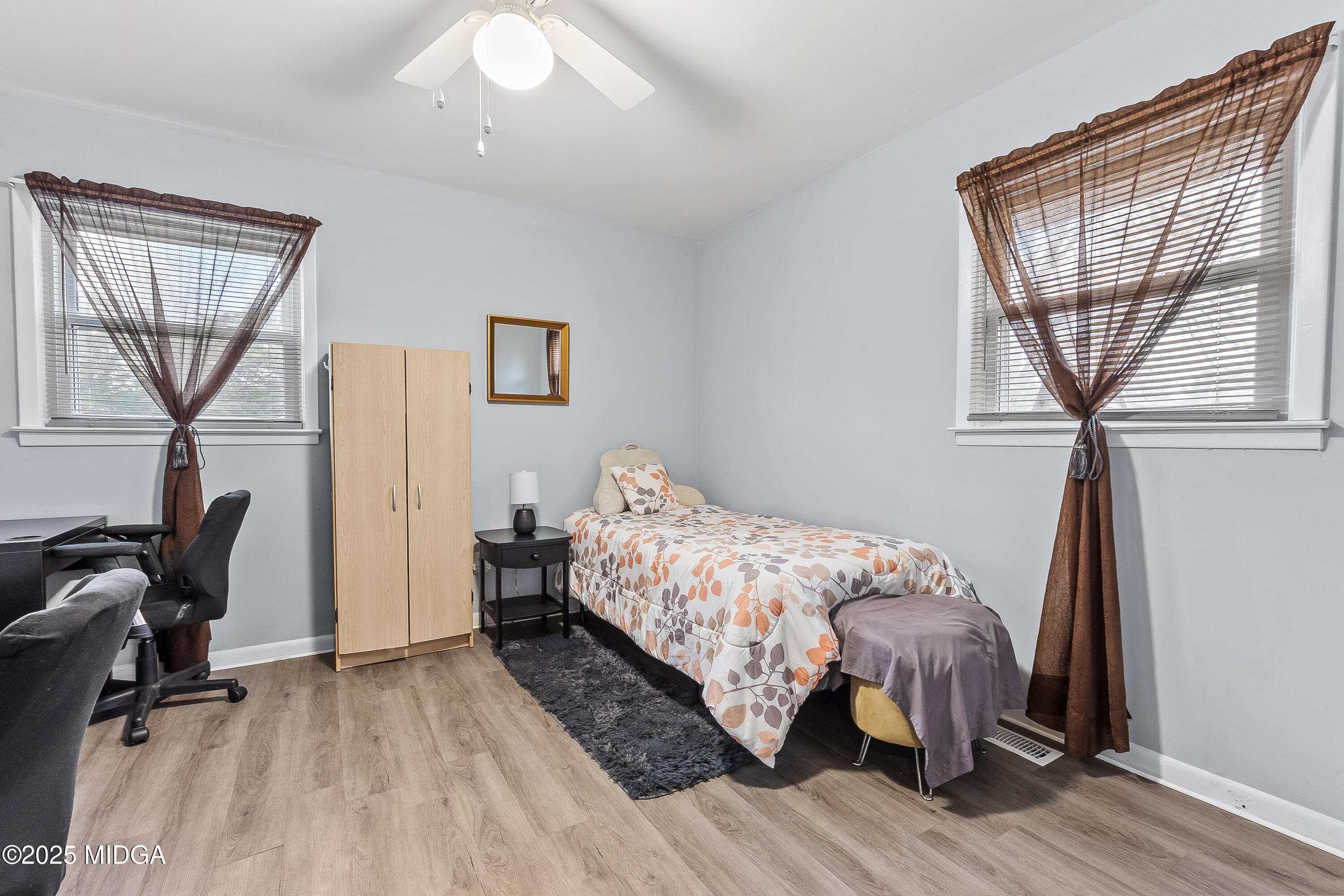 121 Crestwood Road Warner Robins, GA 31093 - Photo 39 of 47 a bedroom with a bed a chair and a window