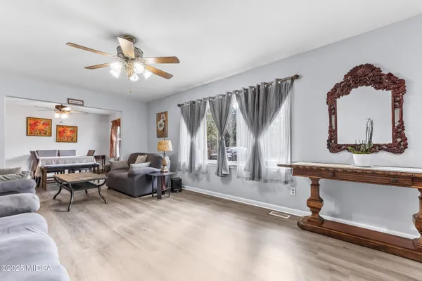 a living room with furniture gym equipment and a large window
