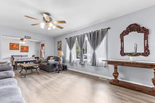 a living room with furniture gym equipment and a large window