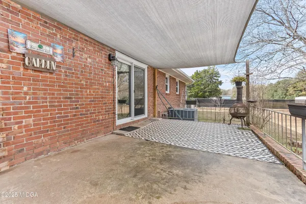 a view of a porch with wooden floor and fence