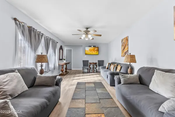 a living room with furniture and a chandelier