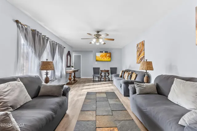 a living room with furniture and a chandelier