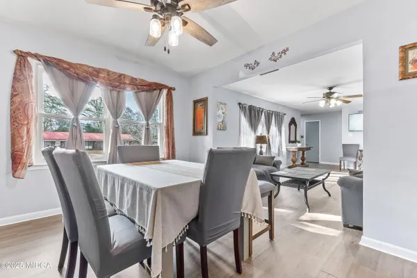 a view of a dining room with furniture window and outside view