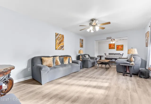 a living room with furniture a couch and a chandelier