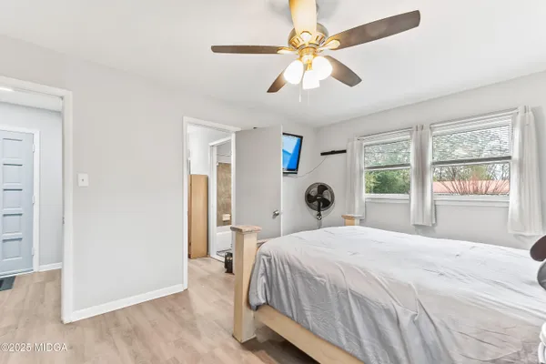 a bedroom with a large bed and a window