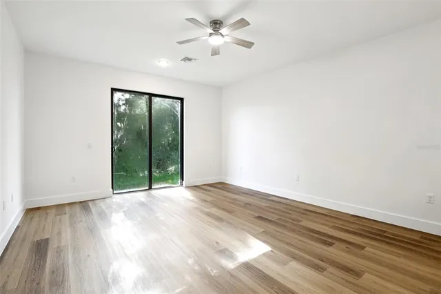 wooden floor in an empty room with a window