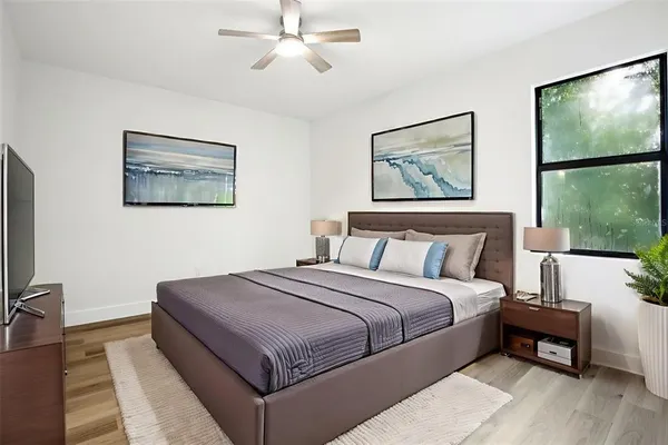 a bedroom with a large bed and a window