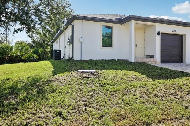 a view of yellow house with a yard