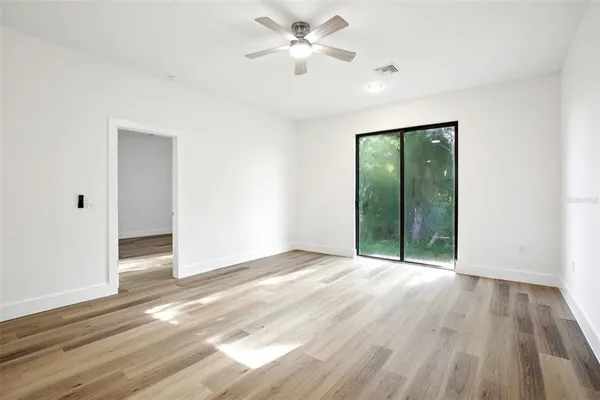 wooden floor in an empty room with a window