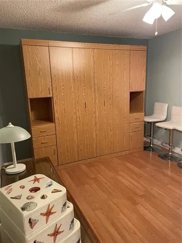 a living room with a bed furniture and a flat screen tv