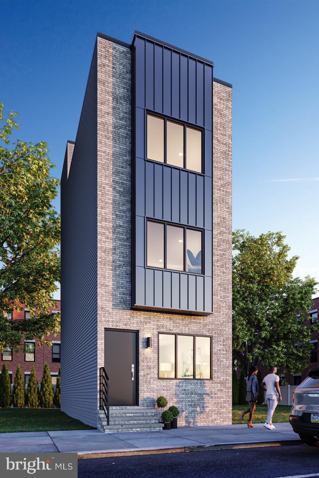 a tall building with a window and a yard