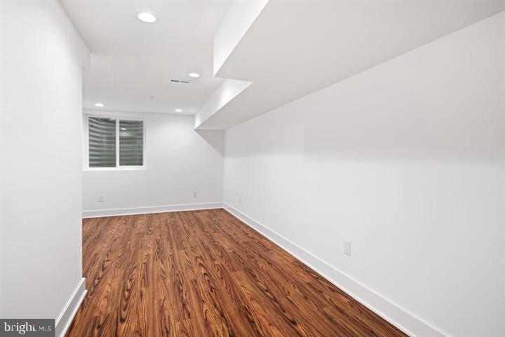2322 Mutter Street Philadelphia, PA 19133 - Photo 15 of 34 an empty room with wooden floor and windows