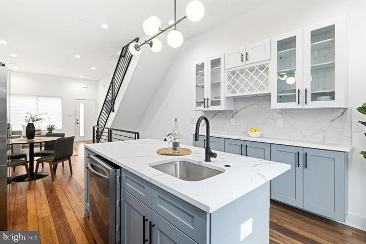 2322 Mutter Street Philadelphia, PA 19133 - Photo 19 of 34 a kitchen with stainless steel appliances a sink a counter top space a dining table and chairs