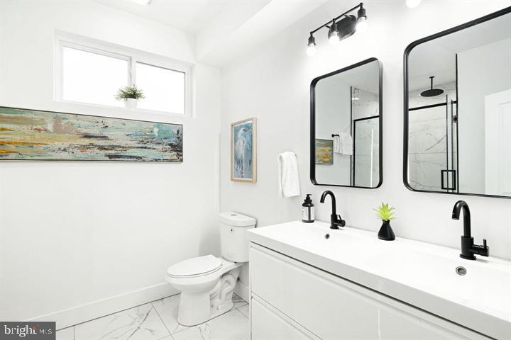 2322 Mutter Street Philadelphia, PA 19133 - Photo 30 of 34 a bathroom with a sink a toilet and mirror