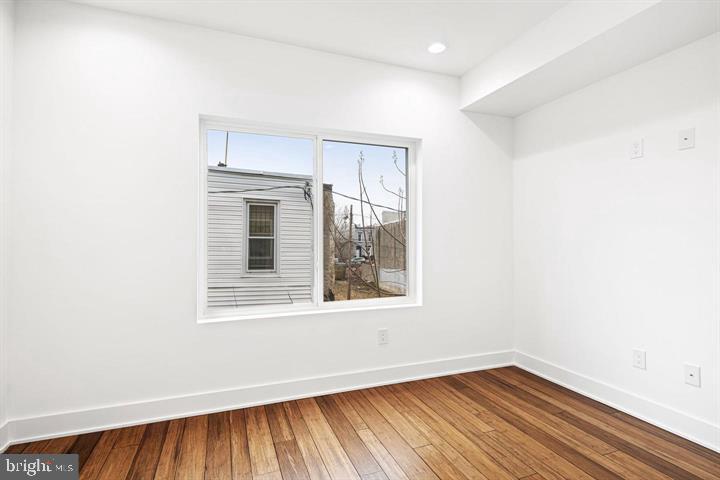 2322 Mutter Street Philadelphia, PA 19133 - Photo 8 of 34 an empty room with wooden floor and windows