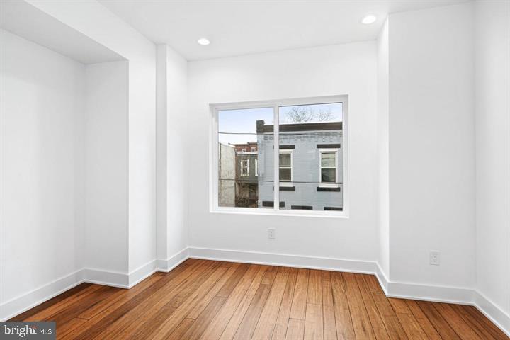 2322 Mutter Street Philadelphia, PA 19133 - Photo 9 of 34 an empty room with wooden floor and windows