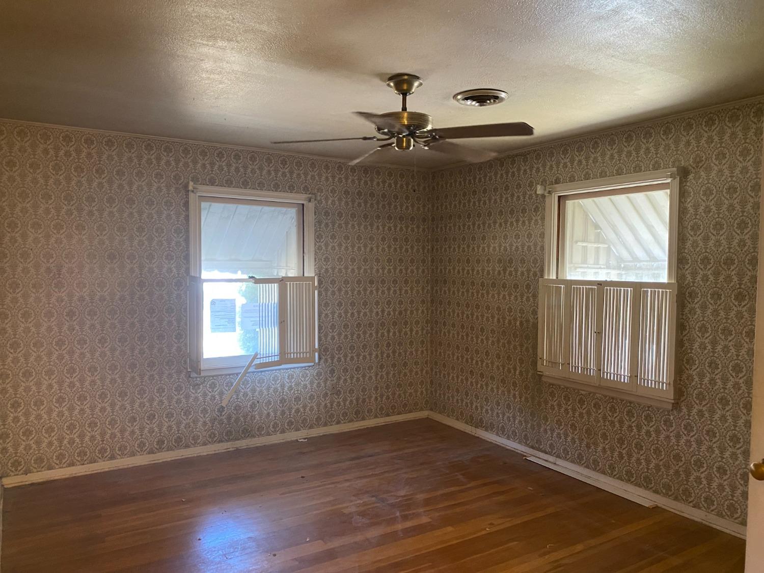 2828 E Street Selma, CA 93662 - Photo 14 of 17 a view of an empty room with wooden floor and a window