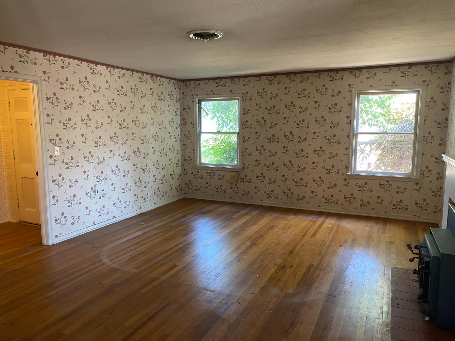 2828 E Street Selma, CA 93662 - Photo 7 of 17 wooden floor in an empty room with a window