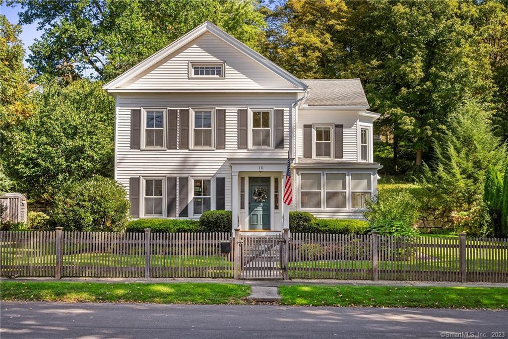 a front view of a house with a garden and plants