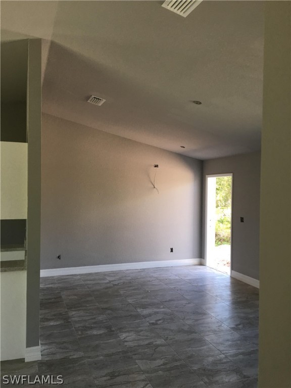 26259 Angelica Road Punta Gorda, FL 33955 - Photo 5 of 8 a view of an empty room with wooden floor and a window