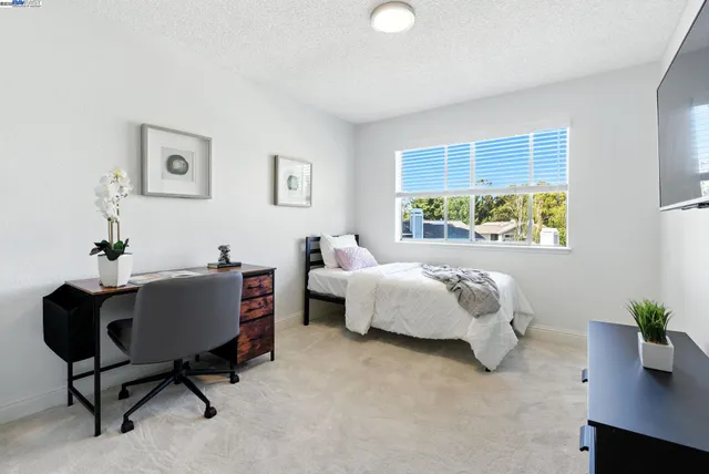 a bed room with a bed and a potted plant