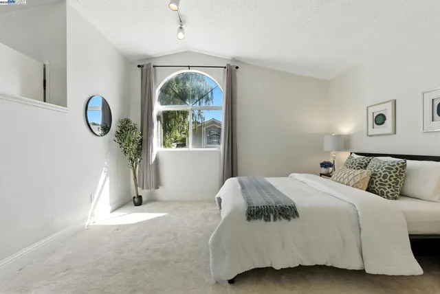 a bedroom with a bed and a window