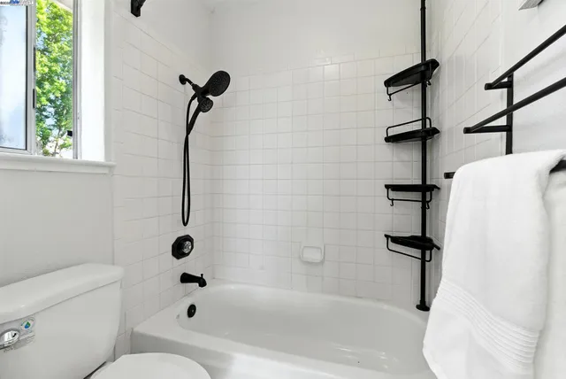 a bathroom with a bath tub with a shower