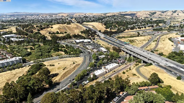 an aerial view of a house with a yard basket ball court and outdoor seating
