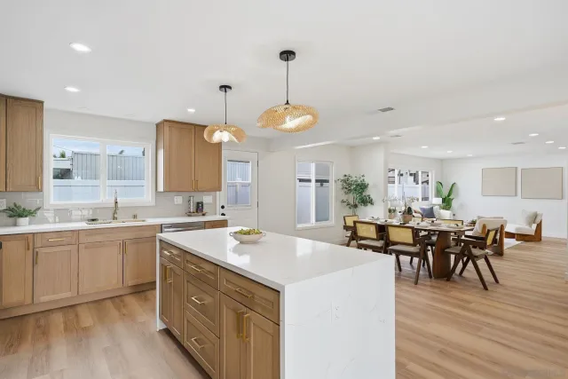 a large kitchen with kitchen island a sink table and chairs