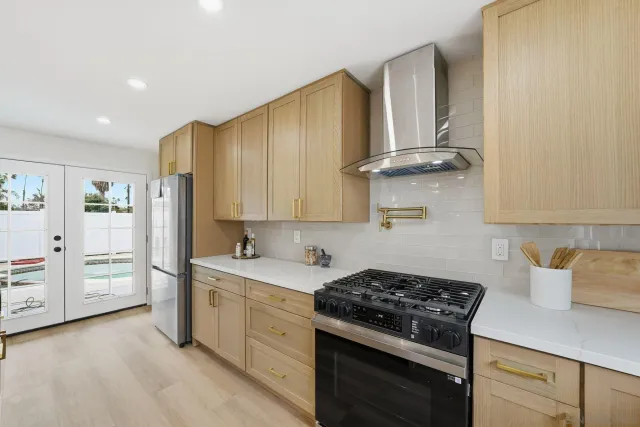 a kitchen with stainless steel appliances granite countertop a sink stove and cabinets