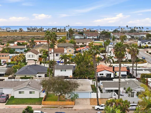 an aerial view of residential houses with city view