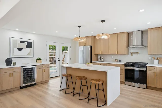 a kitchen with kitchen island white cabinets and white appliances