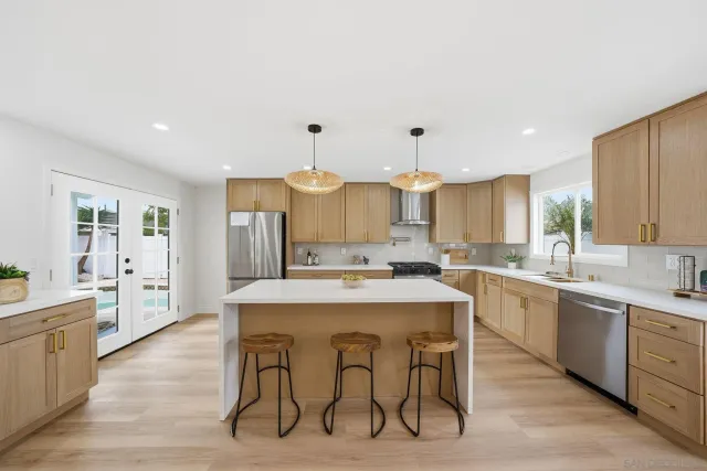 a large kitchen with a table and chairs