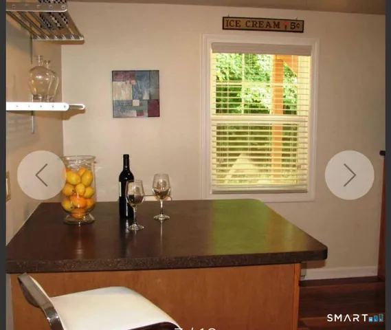 a bathroom with a granite countertop sink and a large mirror