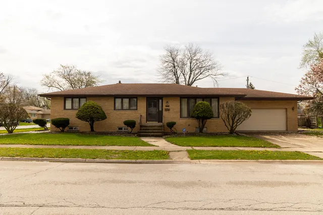 a view of a house with a patio and a yard