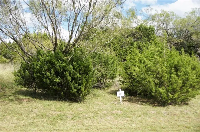 a view of a swimming pool with a yard from a balcony